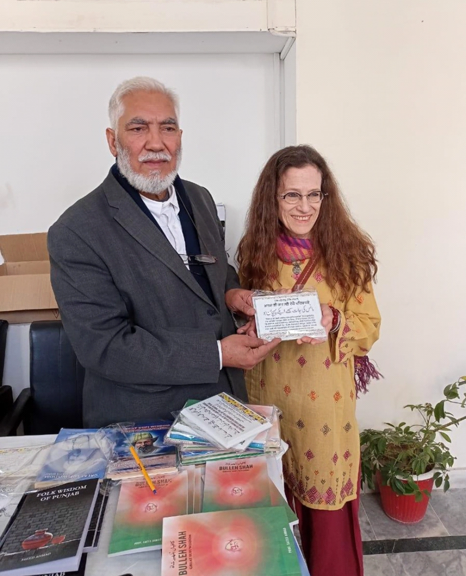 Amie with distinguished Punjabi folklore and Sufi mysticism scholar Prof. Saeed Ahmed with his books at FJWU series, Rawalpindi, Feb. 2023